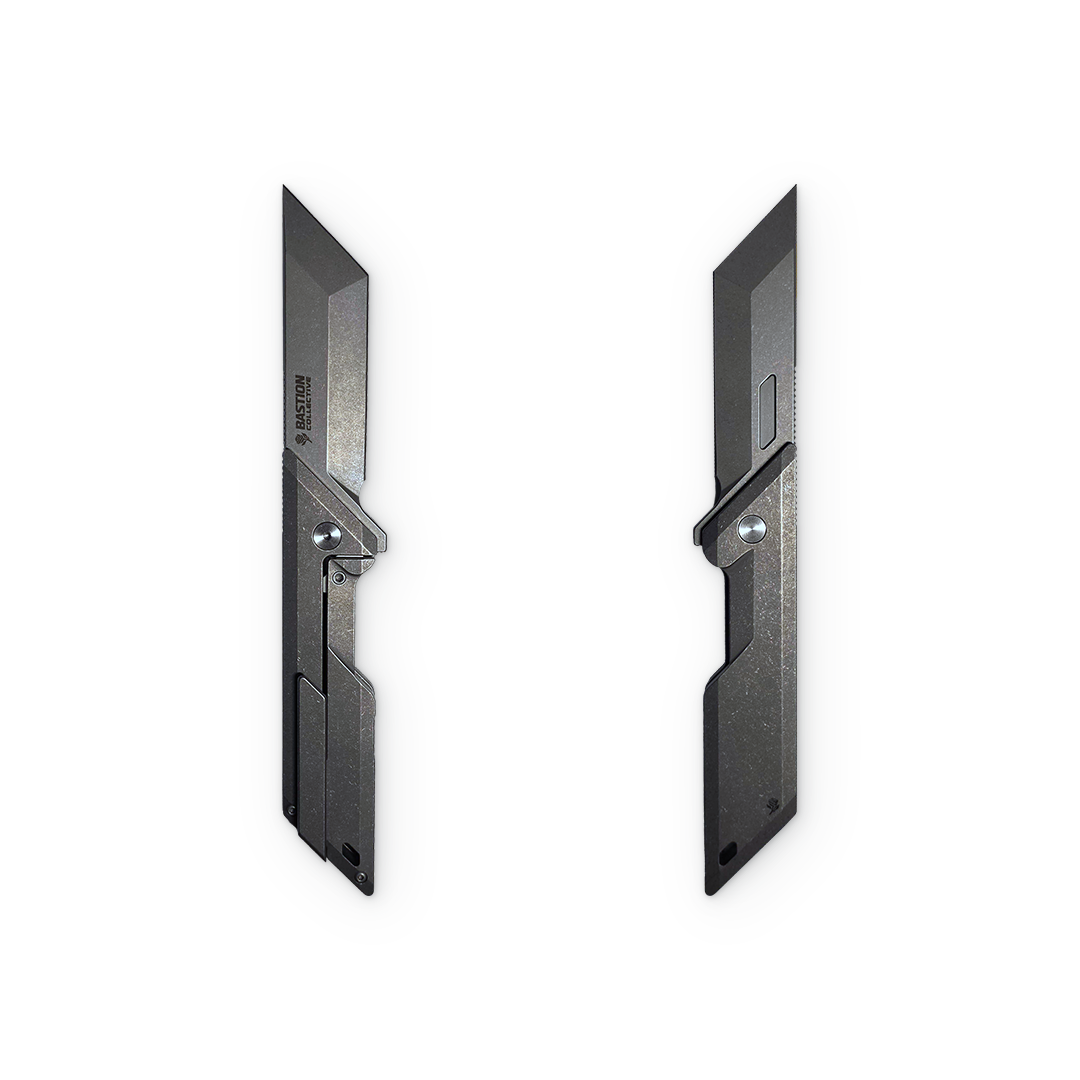 Two black tactical utility knives shown side by side on a plain white background.